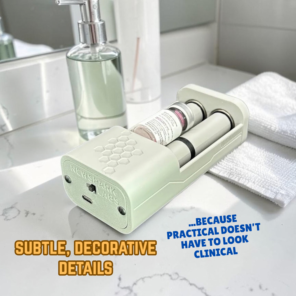 A gray, portable electronic vial rolling device with a honeycomb pattern on top, shown on a bathroom counter. one small cylindrical vial sits inside, nestled between two rollers. Text overlay says, 'Subtle, Decorative Details ...because practical doesn't have to look clinical.'