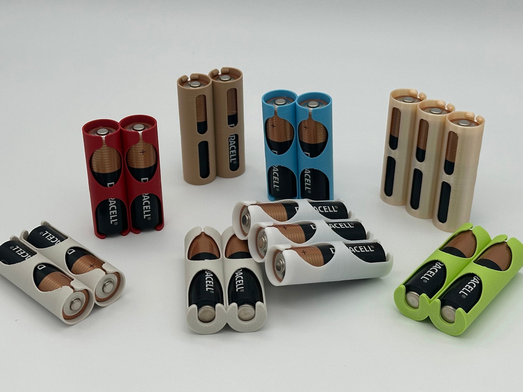 Assorted batteries of different colors and sizes on a white background