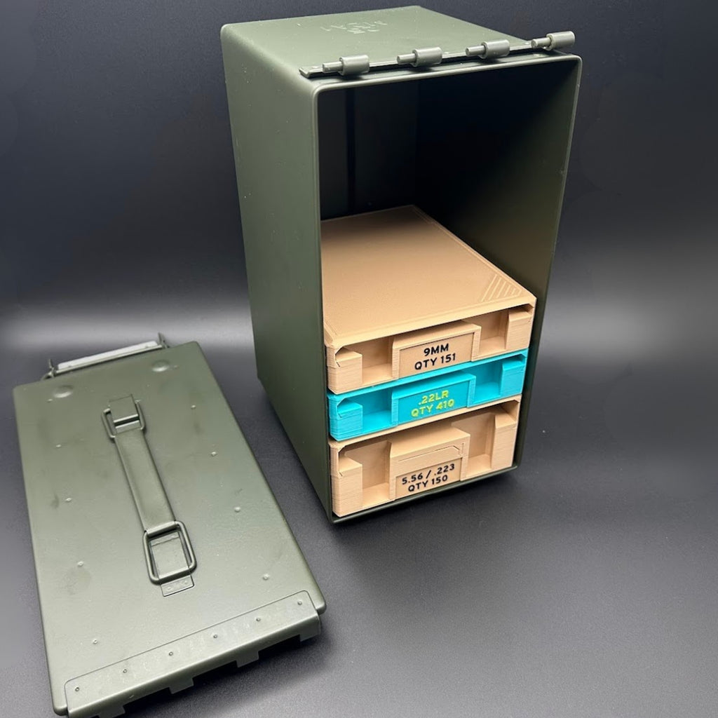 Green metal ammunition box with stacked ammunition organizer trays inside, all on a gray background
